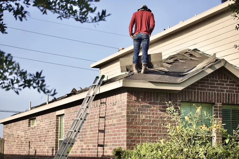 Professional roofer working on a residential roof in Heart of Arlington